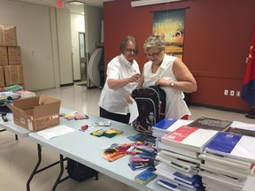 Val Wicks (L), program director for Salvation Army Regina branch helps Laura Ross (R), MLA for Regina Qu'Appelle Valley pack a backpack for the annual Salvation Army Backpack Program on Tuesday morning at the Haven of Hope Community Ministries. This year the Salvation Army in Regina will give out 1,033 backpacks to children in the city for back to school.