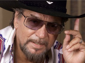 In this Aug. 1999 file photo, country music legend Waylon Jennings poses in Nashville, Tenn. Saskatchewan Premier Brad Wall is sporting a new ride, a white Cadillac convertible once owned by country music legend Jennings.