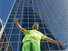Wes Attwood stands on a public bench at the Easter Seals Drop Zone in Regina, Sask. on Saturday Aug. 20, 2016. The self-described adrenaline junkie rappelled down the tower behind him earlier in the day.