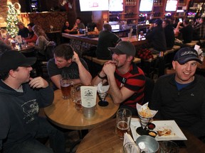 Patrons have a beer at the Wood Buffalo Brewing Co. in Fort McMurray in 2014.