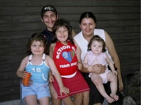 Eric Cleveland and Melanie Geddes sit with their three children in this undated photo.