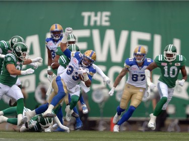Andrew Harris #33 of the Winnipeg Blue Bombers makes some yards during the Labour Day Classic held at Mosaic Stadium in Regina, Sask. on Sunday Sept. 4, 2016.