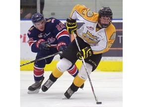 Brandon Wheat Kings forward Cole Reinhar tries to pull away from Regina Pats forward Rykr Cole during a WHL pre-season game at the Co-operators Centre on Saturday.