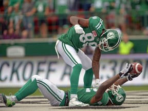 Caleb Holley, 88, celebrates with Saskatchewan Roughriders receiving cohort Naaman Roosevelt during the second quarter of Sunday's CFL game against the Winnipeg Blue Bombers. The celebration was short-lived, though, as the officials ruled that Roosevelt did not make the catch on the play — a call that was confirmed by video review.