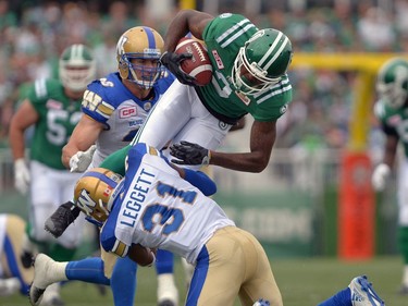 Curtis Steele #2 of the Saskatchewan Roughriders is tackled by Maurice Leggett #31 of the Winnipeg Blue Bombers during the Labour Day Classic held at Mosaic Stadium in Regina, Sask. on Sunday Sept. 4, 2016.