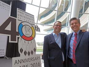 David Sharpe, chair of the board of governors, center right, and Mark Dockstator, president of First Nations University of Canada.