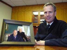 Herb Wheaton of Regina with a picture of his late father Don Wheaton, along with his wife Marion, in this file photo from 2012. The Wheaton family will receive the Family Business Award of Excellence at the EY Entrepreneur of the Year  Prairies 2016 awards gala in Calgary Oct. 13.