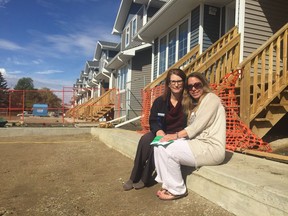 Jackie Gerlach (r) sits with Kelly Holmes-Binns (l) CEO of Habitat for Humanity Regina, at Hultain Crossing. Gerlach was given the key to her future home on Thursday at a sod turning for the second phase of the development.