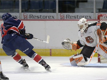 Medicine Hat Tigers goalie stops Regina Pats forward Austin Wagner's breakaway shot during a game held at the Brandt Centre in Regina, Sask. on Saturday Sept. 10, 2016.