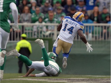 Quincy McDuffie #14 of the Winnipeg Blue Bombers scores a touchdown while Kacy Rodgers #45 of the Saskatchewan Roughriders misses the tackle during the Labour Day Classic held at Mosaic Stadium in Regina, Sask. on Sunday Sept. 4, 2016.