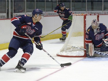 Regina Pats forward Brady Pouteau (4) carries the puck while goalie Tyler Brown remains vigilant during a game held at the Brandt Centre in Regina, Sask. on Saturday Sept. 10, 2016.