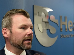 Former Saskatchewan health minister Dustin Duncan shown in 2013 announcing plans to privatize hospital laundry services.