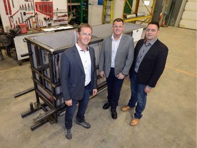 Sean Frisky, from left, CEO of Ground Effects Environmental, John Miller, COO of Living Sky Water Solutions Inc., and Ryan Van Dijk, CEO of Living Sky Water Solutions Inc., stand in front of reactor vessel at Ground Effects Environmental in Regina.