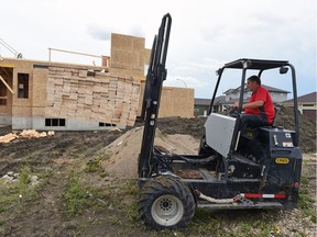 Norm Cowan with Sherwood Co-op unloads lumber on the 6200 block of Balzer Street in early August. Home builders started on 252 housing units in August, up 74 per cent from 145 in August 2015, according to Canada Mortgage and Housing Corp. (CMHC) .