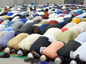 Members of the Muslim community pray to mark the end of Ramadan and the start of the holiday Eid-ul-Fitr at the Canada Centre Building in Evraz Place in Regina.