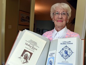 Gerry Moen the former National Chair of the Co-workers of Mother Teresa with a scrapbook from her history with Mother Teresa