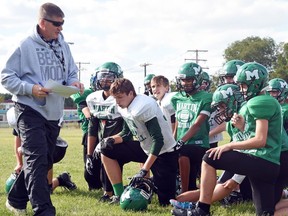 Martin Monarchs head coach Blaine Pearce, left, talks to his players at Tuesday's practice. The Monarchs are to begin their season Thursday, 5:15 p.m., against the Johnson Wildcats at Leibel Field.