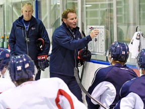 Regina Pats assistant coach and assistant GM Dave Struch, right, and head coach John Paddock discuss strategy with the players during Thursday's practice at the Co-operators Centre.