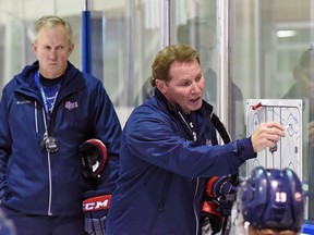 Regina Pats assistant coach Dave Struch, right, instructs the WHL team's players as head coach John Paddock looks on.