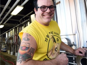 Mark Heise, Rebellion Brewing's vice-president and brewmaster, showing off his Rebellion tattoo.