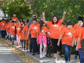 Students from Sacred Heart Community School in Regina participate in a neighbourhood walk for Orange Shirt Day at the school as part of the movement toward Truth and Reconciliation and a way to recognize the damage done by residential schools.