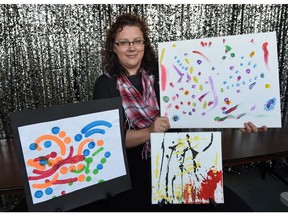 Tanya Gallagher, social director at Riverbend Crossing Memory Care Community, with some art created by residents with dementia. Residents' paintings will be auctioned Friday night with proceeds donated to the Alzheimer Society of Saskatchewan.