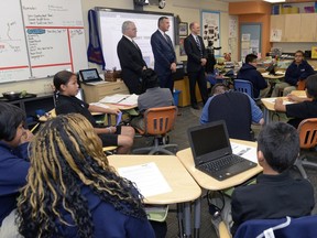 (L-R) Paul Hill of The Hill companies, Education Minister Don Morgan and  Mosaic CEO Bruce Bodine answer questions from students at Regina's Mother Teresa Middle School, the subject of an innovative "social impact bond."