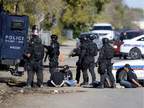 Police execute a high-risk warrant on the 1200 block of Angus Street Tuesday morning. At least seven people were taken into custody.