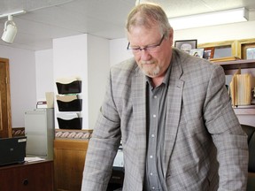 Sunset Cemetery manager Marc L'Hoir looks at blueprints of a potential Bible theme park that could be built near the city of Moose Jaw.