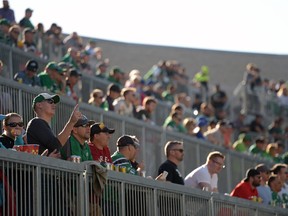 Bryan Feltin, left, gestures upwards from the popular Terrace section of the new Mosaic Stadium on Saturday.