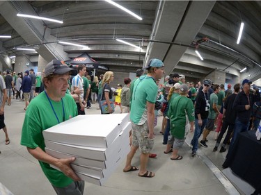Dave Smith of Western Pizza carries in five more boxes of pizza from its south restaurant at the new Mosaic Stadium test event featuring the University of Regina Rams vs. the University of Saskatchewan Huskies in Regina, Sask. on Saturday Oct. 1, 2016.