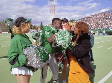 Saskatchewan Roughriders receiver Don Narcisse is congratulated by his mother, Dorothy, after breaking the CFL's consecutive-games pass-receptions record in 1995.