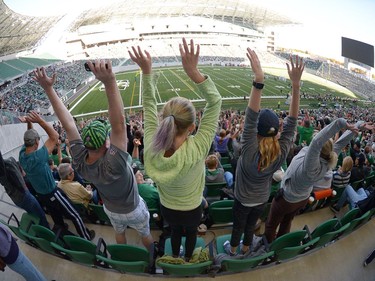 Fans do "the wave" at the new Mosaic Stadium test event featuring the University of Regina Rams vs. the University of Saskatchewan Huskies in Regina, Sask. on Saturday Oct. 1, 2016.