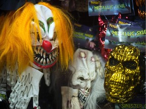 (FILES) This file photo taken on October 21, 2013 shows, Halloween masks on a wall at Spirit Halloween costume store in Easton, Maryland.  A series of creepy clown sightings across the United States has caused a wave of hysteria, forcing police and schools to scramble to contain spreading jitters, and even the White House to weigh in.  /