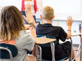 School children sit in class.