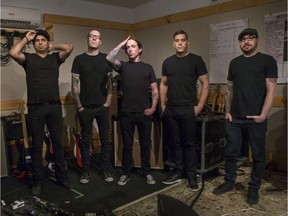 Members of Canadian rock band Billy Talent — Ian D'Sa (left), Aaron Solowonluk, Ben Kowalewicz, Jon Gallant, and Jordan Hastings — pose for a photo in their Toronto rehearsal space.