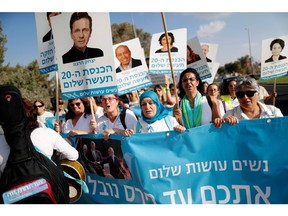 Israeli and Arab-Israeli activists from the Women Wage Peace organization rally outside the Israeli parliament in Jerusalem, on Oct. 31, to ask Israeli and Palestinian leaders to "take courage for a possible peace."