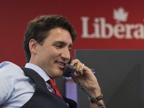 Prime Minister Justin Trudeau works the phones at Liberal headquarters in Ottawa, on Oc. 19.