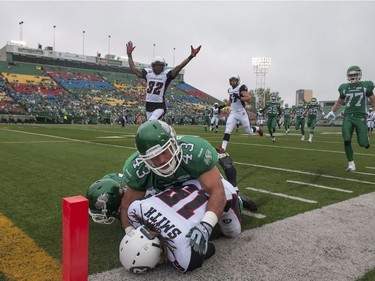 Saskatchewan Roughriders linebacker Kevin R?gimbald takes down Ottawa Redblacks wide receiver Jamill Smitth during first half of CFL pre-season football action in Regina, Sask., Saturday, June 14, 2014.