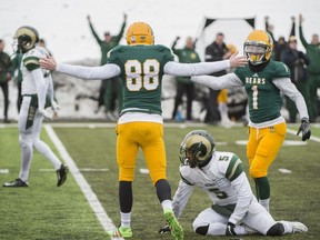 Kicker Brent Arthur, 88, and Adam Zajdel, 1, of the University of Alberta Golden Bears celebrate what turned out to be a game-winning field goal against the visiting University of Regina Rams on Saturday. Alberta won 19-18.