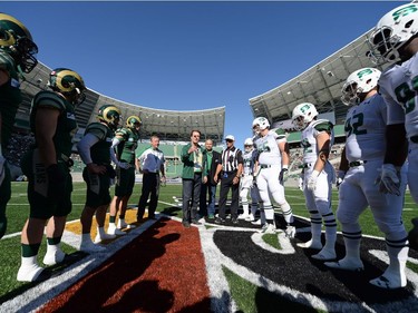 Mayor Michael Fougere flips the coin before the start of the University of Regina Rams' game against the University of Saskatchewan Huskies at the new Mosaic Stadium in Regina.  This is the first event ever held at the new stadium.