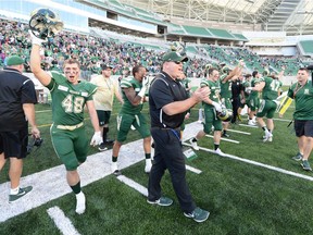 University of Regina Rams head coach Steve Bryce, centre, celebrates Saturday's 37-29 victory over the University of Saskatchewan Huskies at the new Mosaic Stadium.