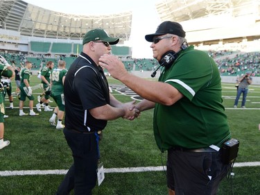 University of Regina Rams' head coach Steve Bryce, left, shakes hands with the University of Saskatchewan Huskies head coach head coach Brian Towriss after the Rams defeated the Huskies  at the new Mosaic Stadium in Regina.  This is the first event ever held at the new stadium.