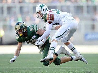 University of Regina Rams' Riley Wilson (83) and the University of Saskatchewan Huskies Spencer Krieger collide in mid air at the new Mosaic Stadium in Regina.  This is the first event ever held at the new stadium.