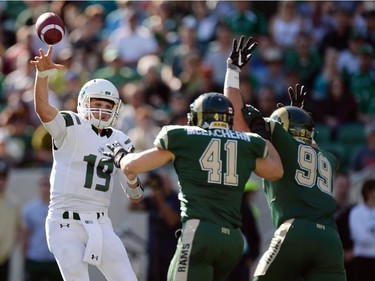University of Saskatchewan Huskies  QB Kyle Siemens throws the pass over a pair of  University of Regina Rams' defenders at the new Mosaic Stadium in Regina.  This is the first event ever held at the new stadium.