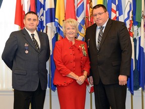 Lt. Gov. Vaughn Solomon Schofield, middle, presents Kalvin Jones, left, and Darryl Morin with the the Royal Canadian Humane Association Bravery Award at Government House in Regina on Oct. 17, 2016. The pair are paramedics in the Keewatin Yatthe Regional Health Authority who responded to an emergency call at the Dene High School in La Loche.