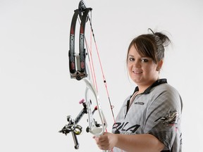 Madison Hart, shown with her compound bow, is an accomplished archer.