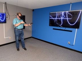 Rob Bryanton, president of Talking Dog Studios, demonstrates the new virtual reality arcade The Grid VR Arcade in Regina.