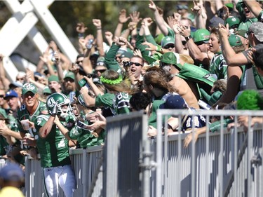 Saskatchewan Roughriders slotback Weston Dressler (#7) jumps up into the stands after catching for a touchdown against the Winnipeg Blue Bombers during the Labour Day Classic game held at Mosaic Stadium in Regina, Sask. on Sunday Sept. 2, 2012.