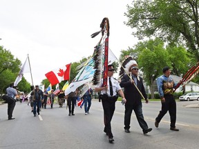 From left, Deputy police chief Dean Rae, Chief Myke Agecoutay from the Muscowpetung Saulteaux First Nation, FSIN Chief Bobby Cameron during the annual smudge walk through North Central Regina on June 2, 2016.